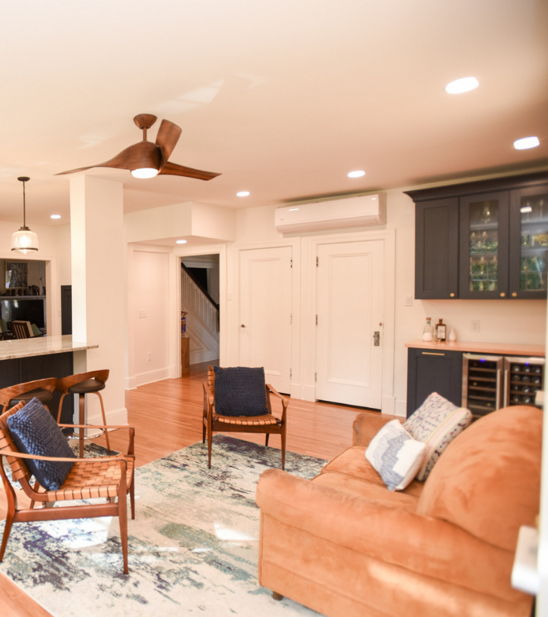 Modern living area with bar seating, built-in cabinets, and cozy seating by Build Dayton.